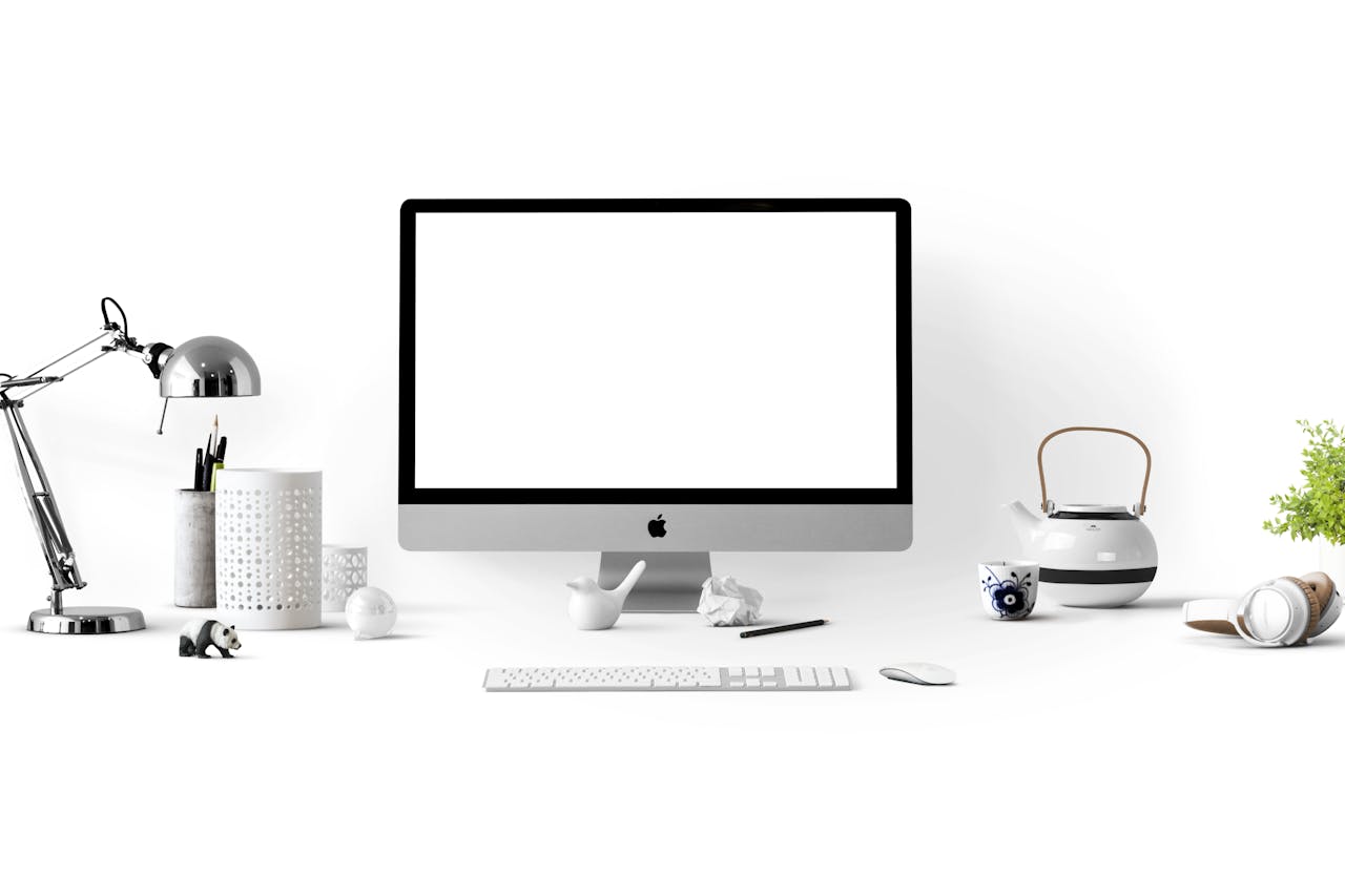 services-01 Minimalist office desk with an iMac, lamp, and stationary, perfect for tech backgrounds.
